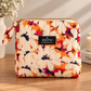 Handmade Tangerine Daisies quilted zip pouch – orange daisy floral print with fabric knot zipper pull, November limited edition